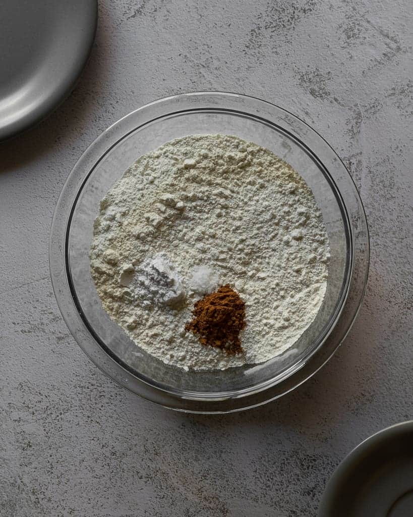 Flour, baking powder, pumpkin pie spice and salt in a bowl. 