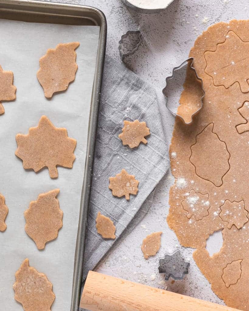 Flat lay of cookie dough and fresh cutouts. off