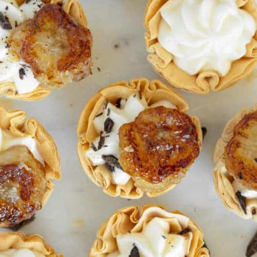 caramelized banana phyllo cups topped with chocolate flakes.