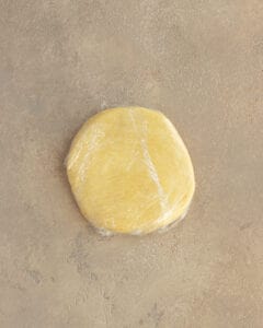 Photo of the jam tart dough shaped into a disc.