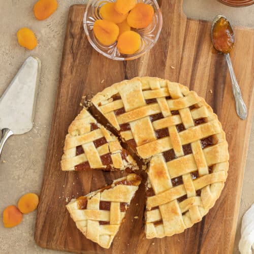 Overhead photo of apricot jam tart on a wooden board.