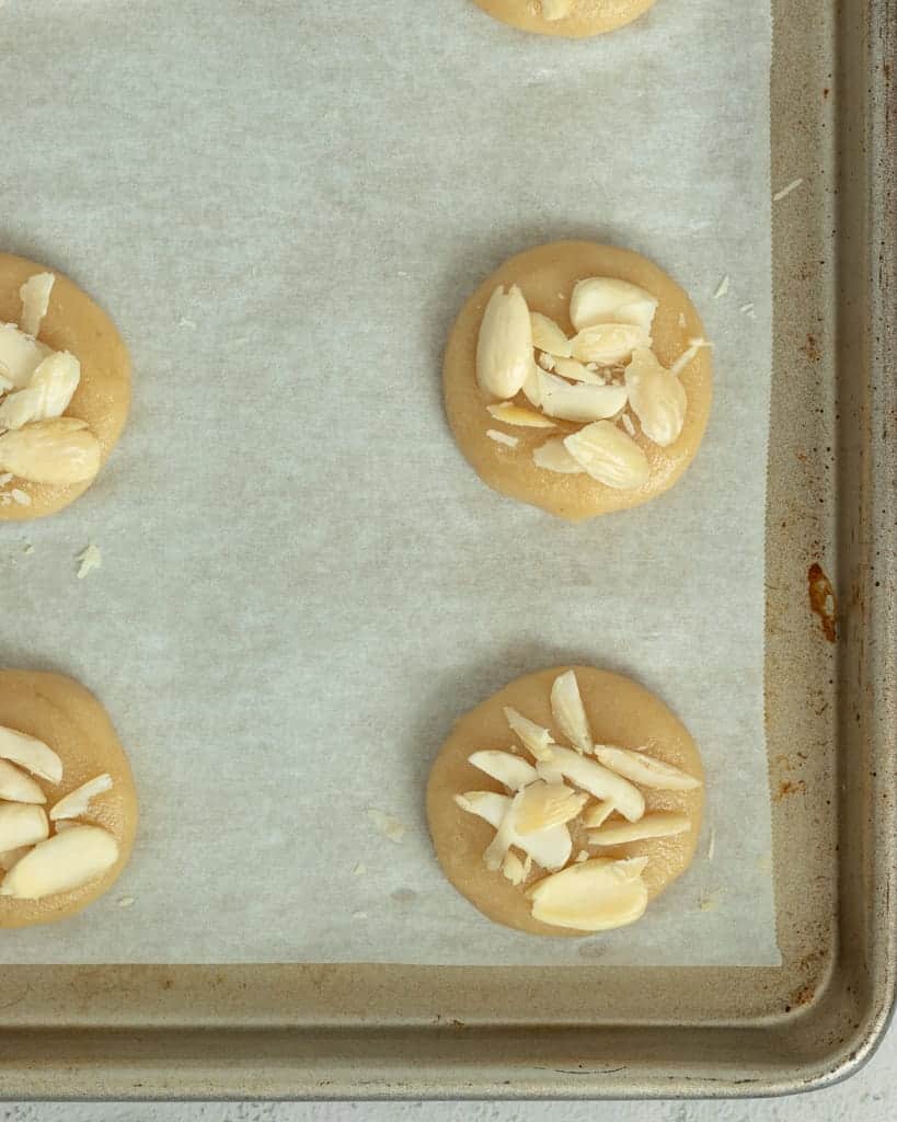 The Greek almond cookies are topped with whole or slivered almonds.