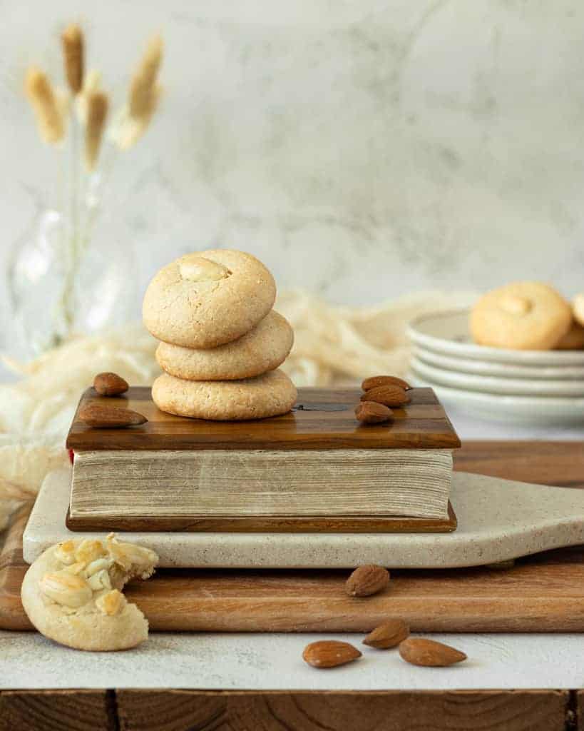 Stack of Greek almond cookies on top of a book.