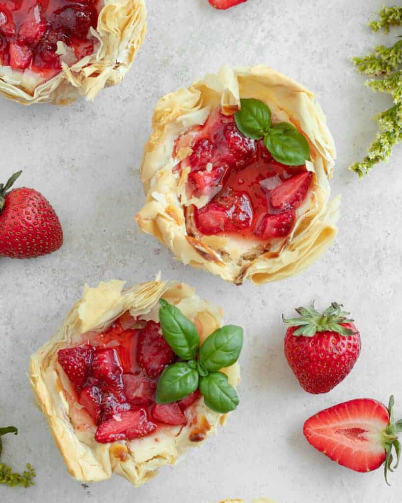 Overhead shot of phyllo strawberry cheesecakes.