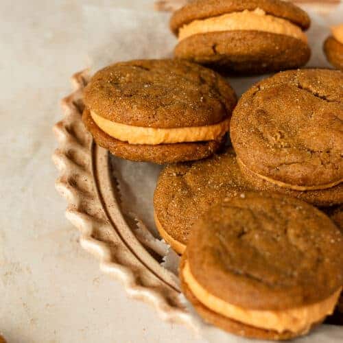 Close up shot of molasses sandwich cookies on a pie pan.