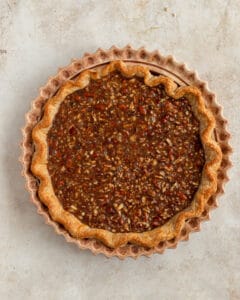 Pour the pecan filling into the pie dish.