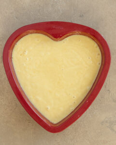 Photo of the heart shaped pan filled with cake batter.