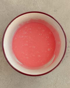 Photo of the rose water glaze in a mixing bowl.