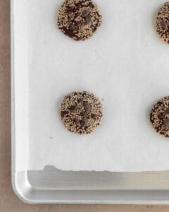 Photo of double chocolate tahini sesame cookies on the baking sheet.