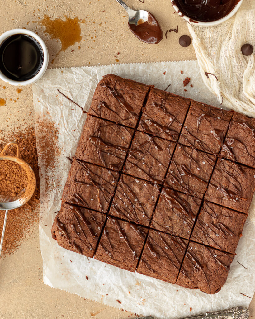 Overhead photo of sliced crème de cacao brownies on top parchment paper.
