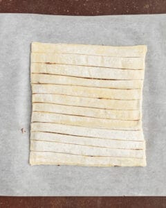 Photo of puff pastry dough cut into strips.