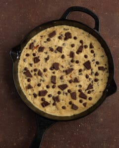 Photo of the unbaked salted caramel skillet cookie topped with chocolate chunks.
