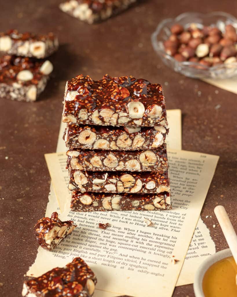 Photo of hazelnut chocolate bars stacked on old vintage books pages.