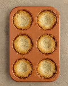 Photo of the muffin pan with baked kataifi nests.