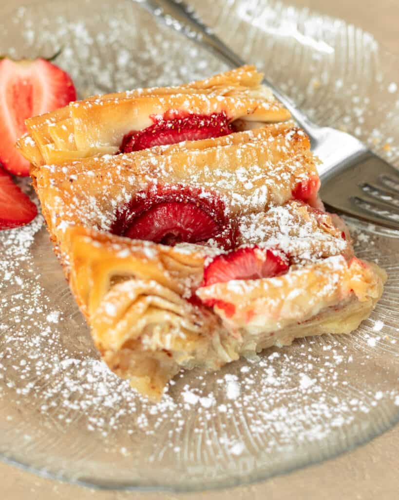 Photo of strawberry phyllo crinkle cake slice in a dessert plate.