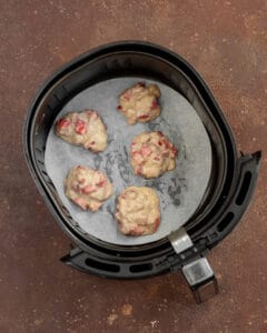 Photo of the fruit fritters inside the air fryer basket.